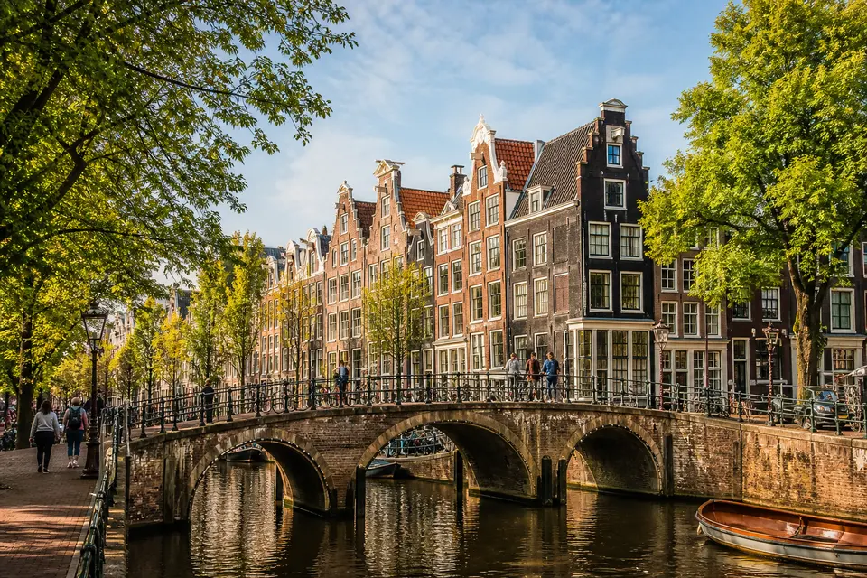 AI-generated illustration of canal houses, bicycles and visitors on an Amsterdam bridge